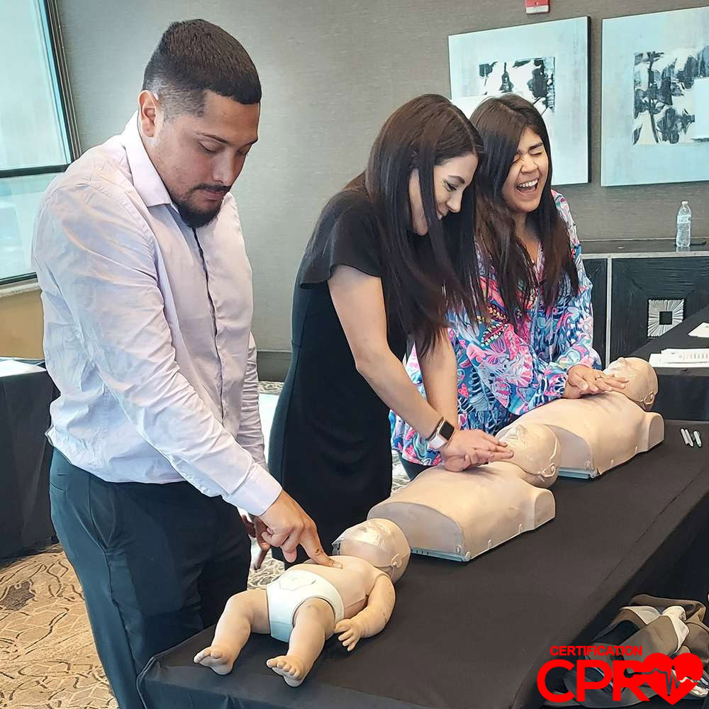 CPR training class in El Paso with students practicing on mannequins.
