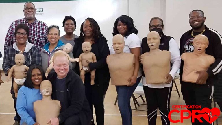 Group CPR training session in El Paso with mannequins for certification.